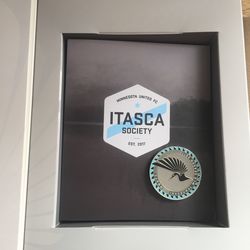 Immediately inside, an Itasca Society booklet and a heavy duty metal “challenge” coin.