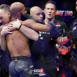 Demetrous Johnson hugs his coach after UFC 216 win.