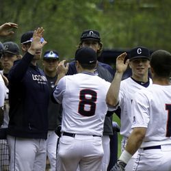 UConn bench celebrates two runs being scored,<br>