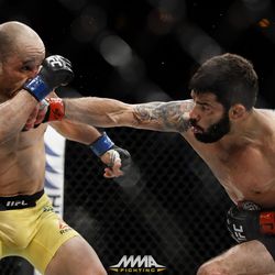 Raphael Assuncao punches Marlon Moraes at UFC 212.