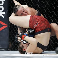Sarah Moras goes for the arm at UFC 215.