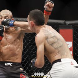 Max Holloway punches Jose Aldo at UFC 212.