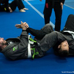 Keanu Reeves practices an armbar on his training partner.