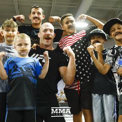 Patrick Cummins poses with his mustache brigade at UFC on FOX 25 open workouts Thursday at UFC Gym in New Hyde Park, N.Y.