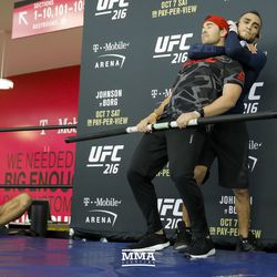 Tony Ferguson choking out his coach, who is holding a stick during the UFC 216 open workouts Thursday at T-Mobile Arena in Las Vegas.