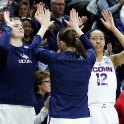 UConn’s Tierney Lawlor (20) celebrates a three-pointer with Saniya Chong (12) and Kyla Irwin (25).<br>