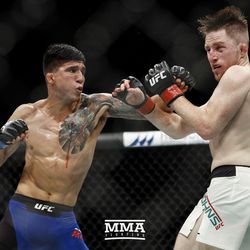 Albert Morales trades punches with Brett Johns at UFC Fight Night 113 on Sunday at the The SSE Hydro in Glasgow, Scotland.