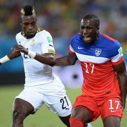 Jozy Altidore reacts in pain next to Ghana’s defender John Boye
