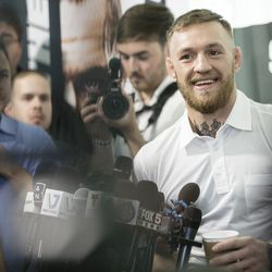 Conor McGregor laughs during media scrum