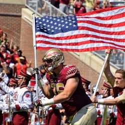 NCSU at FSU:  SR OL Rick Leonard takes the field with the Stars and Stripes during military appreciation day. 