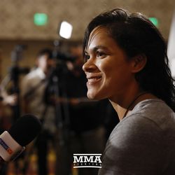 Amanda Nunes listens to a question at UFC 213 media day.