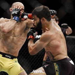 Raphael Assuncao punches Marlon Moraes at UFC 212.