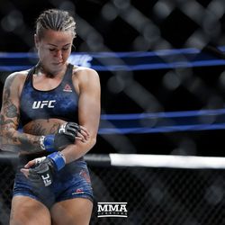 Ashlee Evans-Smith checks her arm after her UFC 215 loss.