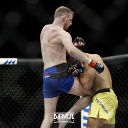 Danny Henry knees the body of Daniel Teymur at UFC Fight Night 113 on Sunday at the The SSE Hydro in Glasgow, Scotland.
