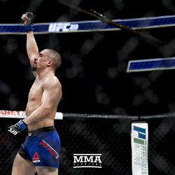 Robert Whittaker celebrates after his UFC 213 fight.