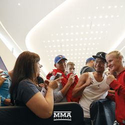 Valentina Shevchenko takes photos with fans at UFC 215 open workouts at the Rogers Place in Edmonton, Alberta, Canada.