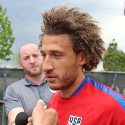 Fabian Johnson talks to the media after practice.
