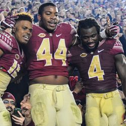 Left to right: RJr QB Deondre Francois, Sr. DE DeMarcus Walker, Jr. RB Dalvin Cook Celebrate after the game in the student section.