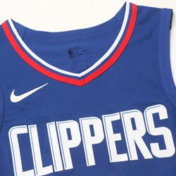 View of the Nike swoosh, “Clippers” wordmark, and neckline on the Clippers’ new blue “Icon edition” jersey.