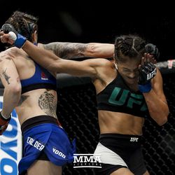 Joanne Calderwood and Cynthia Cavillo trade spinning backfists at UFC Fight Night 113 on Sunday at the The SSE Hydro in Glasgow, Scotland.