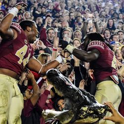 Sr. DE DeMarcus Walker and Jr. RB Dalvin Cook celebrate after the game with the student section.
