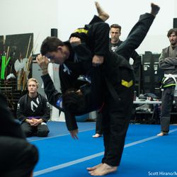 Keanu Reeves watches the instructor demonstrate a throw.