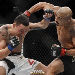 Jose Aldo hits Max Holloway with an overhand right at UFC 212.