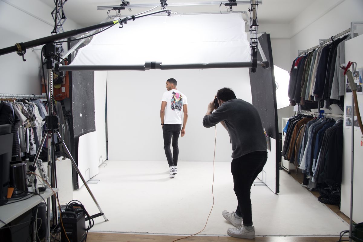 A photographer shoots a model in a studio at ASOS headquarters.