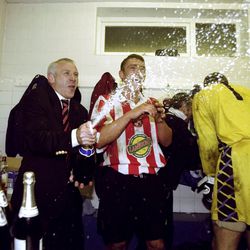 Peter Reid pops the bubbly as Sunderland celebrate promotion at Bury - five games before the end of the season