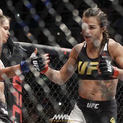 Claudia Gadelha gives  Karolina Kowalkiewicz a high-five before their fight at UFC 212.
