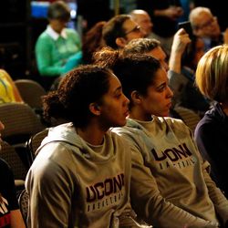 Members of the UConn women’s basketball team watch as their head coach talks about winning the AP Coach of the Year award.<br>