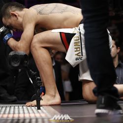Max Holloway takes a knee before entering cage at UFC 212.