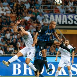Joao Miranda de Souza Filho of FC Internazionale Milano (R) jumps for the ball with Giovanni Simeone of ACF Fiorentina during the Serie A match between FC Internazionale and ACF Fiorentina at Stadio Giuseppe Meazza on August 20, 2017 in Milan, Italy.
