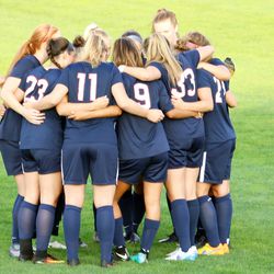 The UConn women’s soccer starting XI huddles before the start of the game.<br>