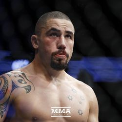 Robert Whittaker looks at replays between rounds at UFC 213.