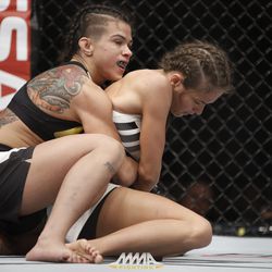 Claudia Gadelha begins to take her opponent’s back at UFC 212.