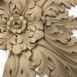 A floral decoration that will be installed in an elaborate scheme for a ceiling. 
