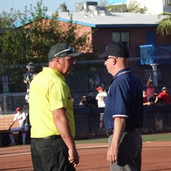 Oregon head coach Mike White argues with first base umpire