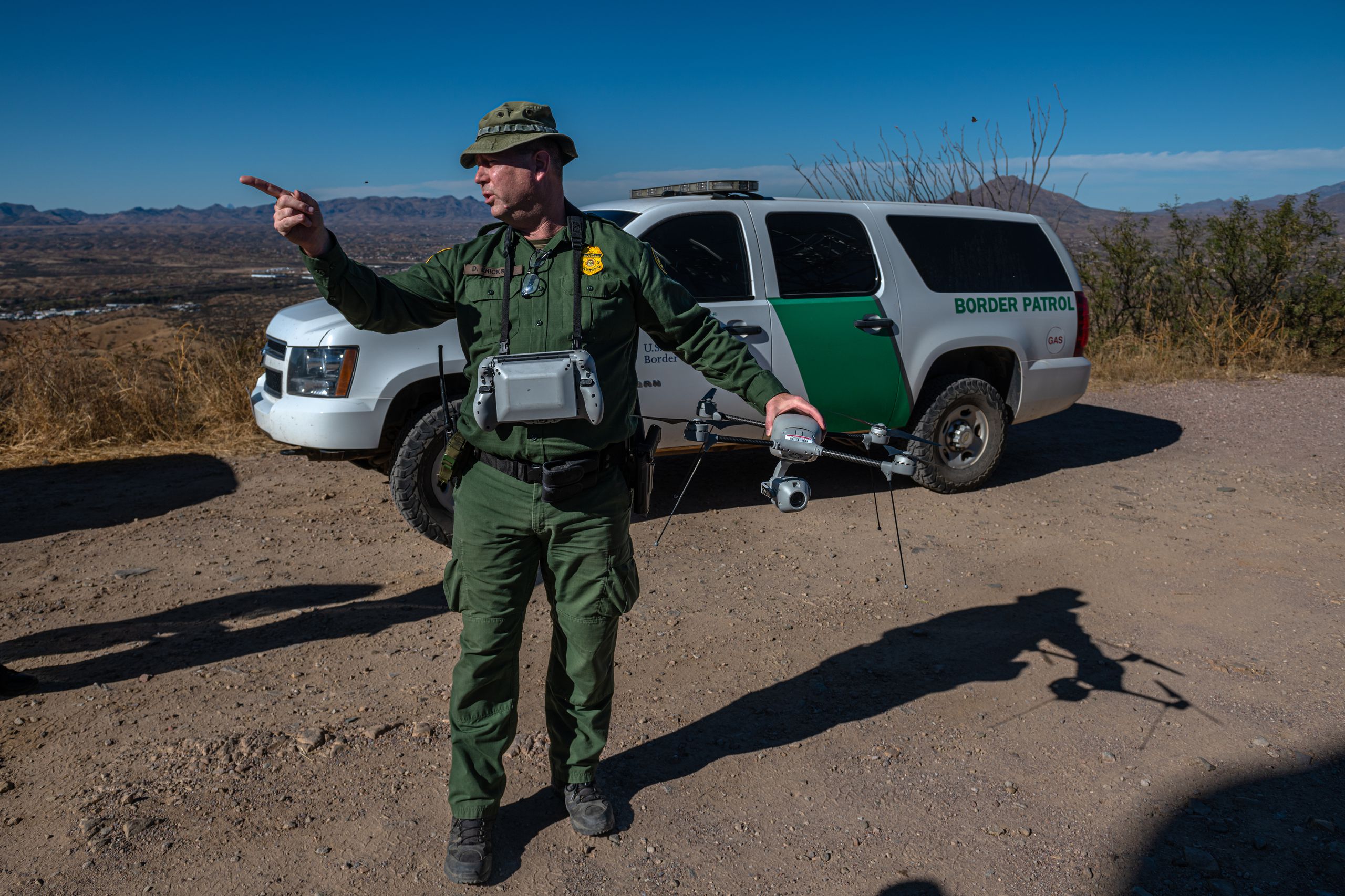 A Border Patrol agent demonstrates the Lockheed Martin Indago-3, a smaller drone used to track migrants through the desert.