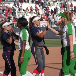 Arizona and Oregon players exchange high fives after Saturday’s game