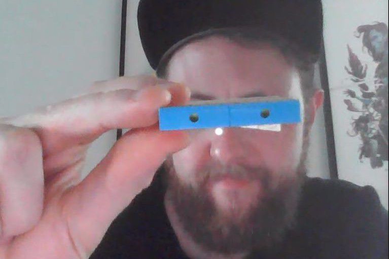 On a video call with The Verge, Lego Ideas creative lead Jordan David Scott holds up the key to the rainbow stripe in front of his eyes — a pair of inverted blue tiles with holes inside.