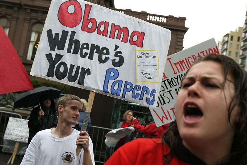 A Tea Party supporter holds a sign asking "Obama where's your papers"