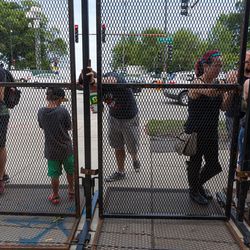 Those who didn’t have tickets hung by the fencing, hoping to catch elusive pokémon