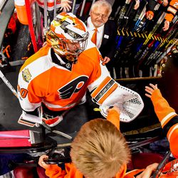 Neuvirth giving a puck to a young fan