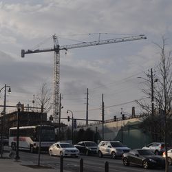 A construction crane looming over the site behind the aquarium.