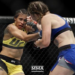 Leslie Smith trades punches with Amanda Lemos at UFC Fight Night 113 on Sunday at the The SSE Hydro in Glasgow, Scotland.
