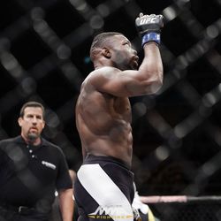 Oluwale Bamgbose points to the sky at UFC 212.